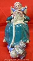 Front view of Royal Doulton Twilight figurine showing elderly woman knitting and cat playing with yarn