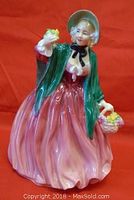 Front view of the Lady Charmian figurine showing detailed face, bonnet, green shawl, pink dress, and flower basket