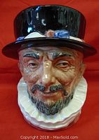 Front view of the Royal Doulton Beefeater Toby Jug showing detailed face with black hat, white collar, and facial features.