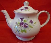 Full view of white Sadler teapot showing shape, handle, spout, and floral pattern.