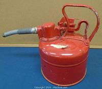 Front angled view showing the flexible metal spout, round body, and red painted metal finish with wear.