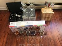 Full view of the lot showing glassware, boxes, and bar accessories.