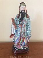 Front view of the 17 inch tall ceramic Asian figurine with detailed colorful robe and facial features