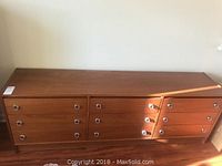Solid wood 9 drawer dresser with modern metal ring pulls, shown from the front and top.