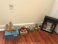 Overview of all items including bamboo boat, fruit wreath in box, and boxed Christmas decorations