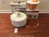 Nesco Food Dehydrator and Guzzini Salad Spinner with both original boxes displayed on floor.