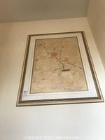 First framed floral art piece with beige background, pink flowers in vase, and gold-tone ornate frame.