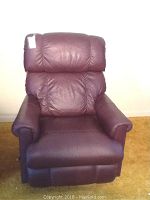 Full view of burgundy vinyl La-Z-Boy recliner chair, front facing showing padded cushions and armrests.