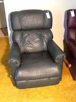 Full frontal photo of dark green Lazy Boy vinyl recliner chair showing padded backrest, seat, armrests in fair condition.