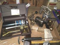 Photo showing the BernzOmatic blowtorch kit in case with propane cylinder and various torch attachments, surrounded by multiple vintage blowtorches and other items