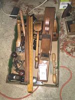 Overview of assorted hand tools in cardboard box