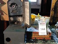 Two metal Reliance Type 441 electric time switches with dials visible, one with case door open showing inside parts.