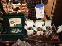Photo showing multiple decorative eggs on display, including boxed eggs and Nutcracker music box