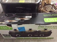 Hamilton Beach roaster oven behind unopened Tru slow cooker box