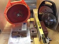 Overall view showing Incra box joint jig, straight edge guide, manual, and saw blades