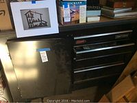 Full view of the black Craftsman work station unit from the front with stickers showing approximate size and brand.