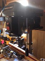 Side view of floor-mounted Porter Cable drill press showing motor housing, column and handle