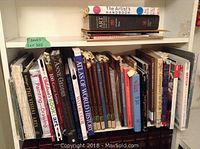 Shelf with a variety of books including art, painting, world history, and guides.