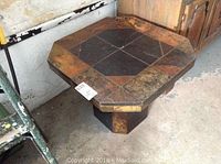 Front angled view showing the octagonal tile tabletop and pedestal base.