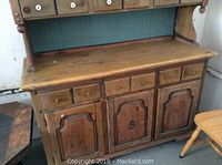 Lower portion front view showing buffet top surface, drawers and cabinet doors