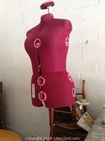 Front three-quarter view of burgundy dress form on metal stand