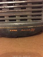 Close-up of T-Fal Multi-Grill Store Away grill logo and base