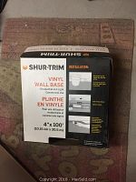 Original boxed roll of Shur-Trim vinyl wall base with installation instructions visible on box.