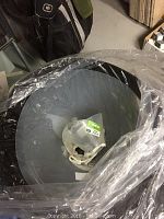 Plastic pet collars wrapped in plastic, showing several collars stacked with one in hand. Visible are transparent collars with plastic clasps.