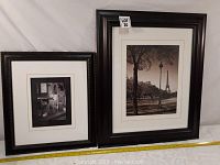 Two framed pictures of Paris, showing Eiffel Tower scene and café scene.