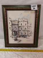 Full view of the framed watercolor painting of Windsor Castle showing the castle gate and walls, inside a wood frame with green border.