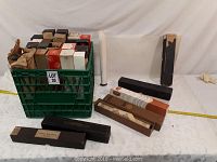 Lot of old mechanical piano rolls, many in original boxes standing inside a crate and some laid out on table.