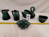 Front view of set showing all five ceramic pieces lined up with tape measure for scale.