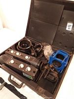 Full view of the open case showing all components inside including control boxes, mounting rings, and blue brackets