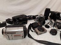 Multiple cameras and accessories arranged on surface