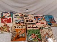 Photo showing 13 comic books including 10 Asterix titles, 2 Rubrique à Brac comics and 1 Objective Lune.