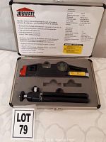 Open carrying case showing JOBMATE laser level, tripod, and storage foam insert with item label