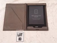 Kobo e-reader inside gray protective case showing screen with charging message.