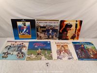 Overall view of 7 LaserDiscs with covers showing titles and cover art including The Ballad of Cable Hogue, Hot Shots Part Deux, Labyrinth, and animated movie The Black Cauldron