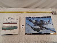 Photo showing the book 'The Bonnie' and the Flying Legends 2010 calendar side by side with a measuring tape for scale.