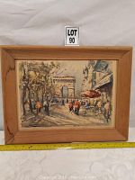 Framed watercolor painting depicting Paris street scene with Arc de Triomphe and cafes, with measuring tape indicating size.