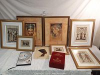Front view of all the Egyptian items laid out, including framed prints, papyrus sheets, and books