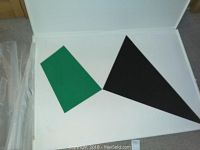 Front view of abstract painting showing green quadrilateral and black triangle on white panel