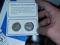 Certificate of authenticity showing two coins with obverse and reverse visible, confirming 90% silver content and dates between 1916 and 1947.