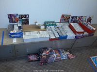Overview of the entire sports card and photo collection spread across surfaces