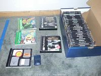Overview of the collection showing various PlayStation 1 game cases including Frogger and SpongeBob games, memory cards, and a box full of additional games.