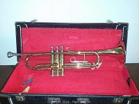 King Cleveland 600 trumpet inside black case with red plush lining, showing trumpet in good overall condition with some scratches