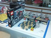 Overview of sealed boxes and loose parts arranged on counter