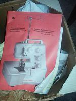 Instruction manual with red cover showing Bernette Funlock 006D serger image and instructions in multiple languages.