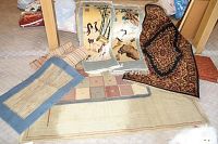 All seven small-to-medium sized area rugs arranged together on floor surface