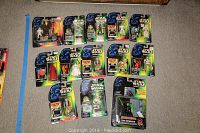 Full lot overview of 15 Star Wars Power of the Force figures in original packaging arranged on carpeted floor.